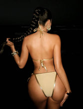 Side view of metallic gold strappy bikini set, ultra low-rise fit highlighting curves, designer swimwear look