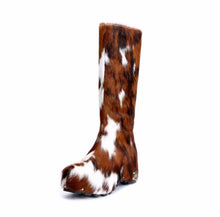 Brown and white cow print boot on a white background