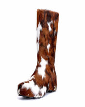 Brown and white cowhide boot on a white background