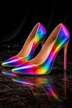 Pair of rainbow high-heeled shoes on a dark surface