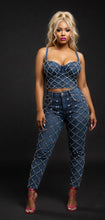 Woman wearing a denim outfit with a black background
Luxury crystal-embellished denim corset top with matching high-waisted jean bottoms styled for a night out
bellarosecouture.com