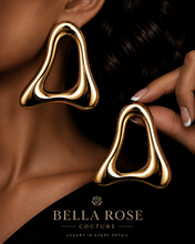 Flux gold sculptural statement earrings on a black and gold luxury Bella Rose Couture background

Close up of  Flux abstract silver earrings with a high shine mirror finish for Bella Rose Couture