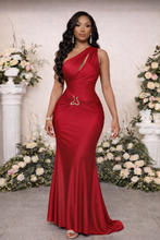 Woman in a red one-shoulder dress standing in front of floral decorations.

Red satin one-shoulder formal gown with elegant ruching, gold waist hardware, and floor-length silhouette, perfect for luxury galas, black-tie events, and evening occasions.